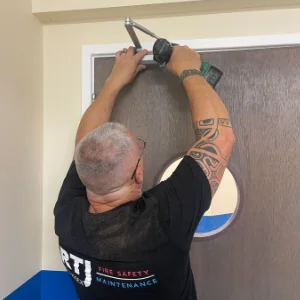 Fire Door Install Employee installing a fire door